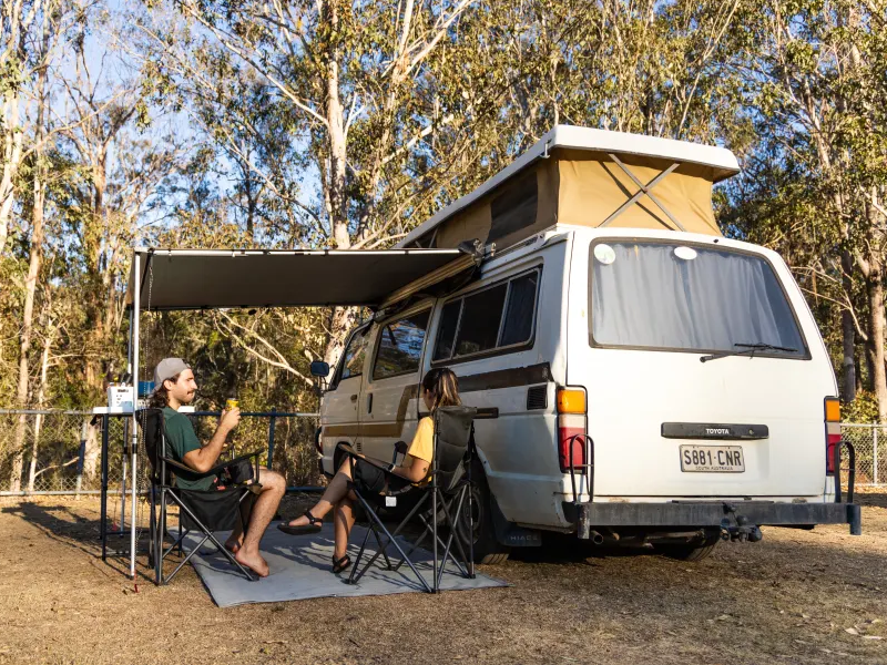 Couple camping at Jimna Base Camp in their Mazda camper van